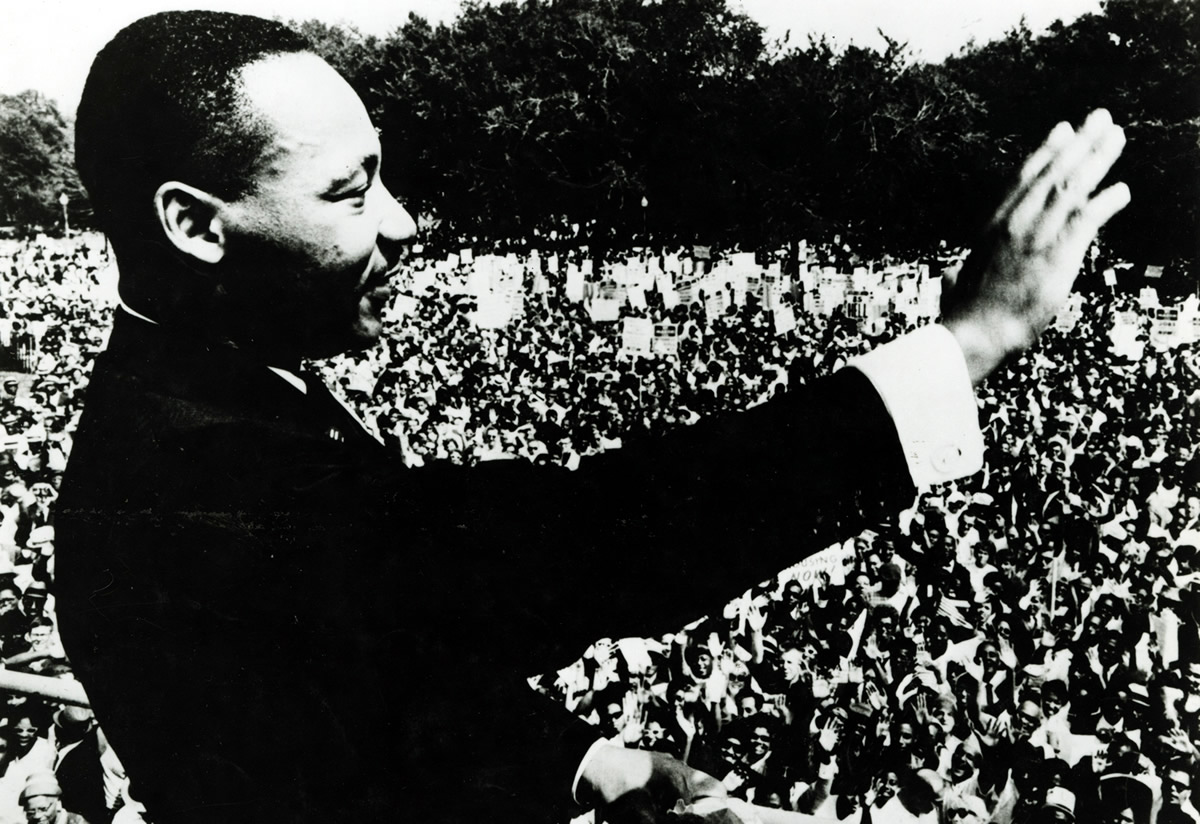 Dr Martin Luther King Jr waving to the crowd from the steps of the Lincoln